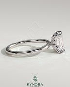 Kynora CJ 2ct emerald claw solitaire engagement ring with petal gallery and accent leaf details, showcasing fine craftsmanship.