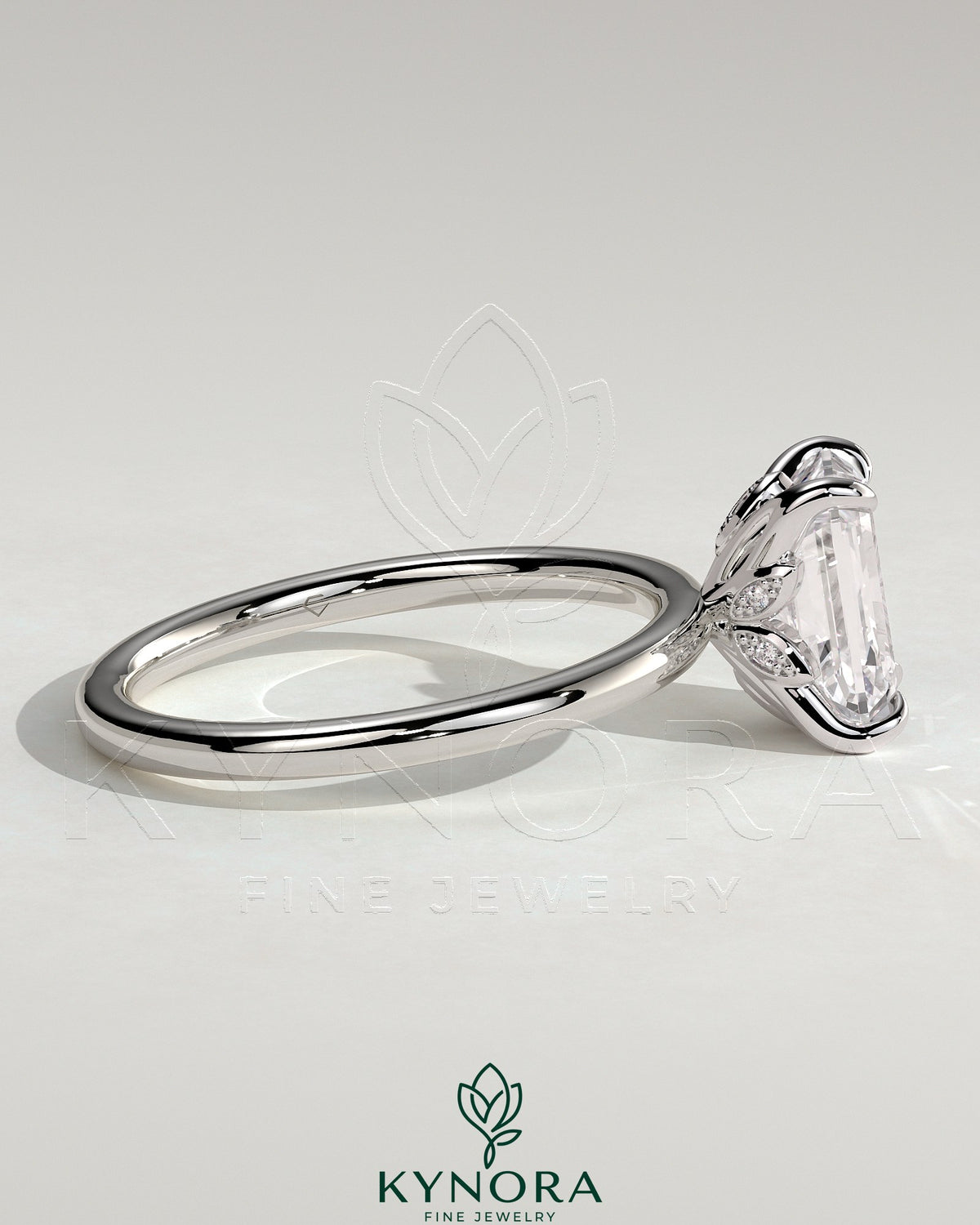 Kynora CJ 2ct emerald claw solitaire engagement ring with petal gallery and accent leaf details, showcasing fine craftsmanship.
