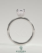 Kynora CJ 2ct emerald claw solitaire engagement ring with petal gallery and accent leaf details, showcasing intricate design and sparkling gemstone.