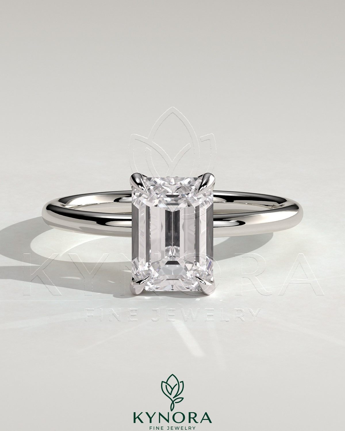 Kynora CJ 2ct emerald claw solitaire engagement ring with petal gallery and accented tiara detail, showcasing intricate design. Main image