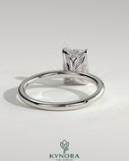 Kynora CJ 2ct emerald claw solitaire engagement ring with petal gallery and accented tiara detail, showcasing intricate craftsmanship.