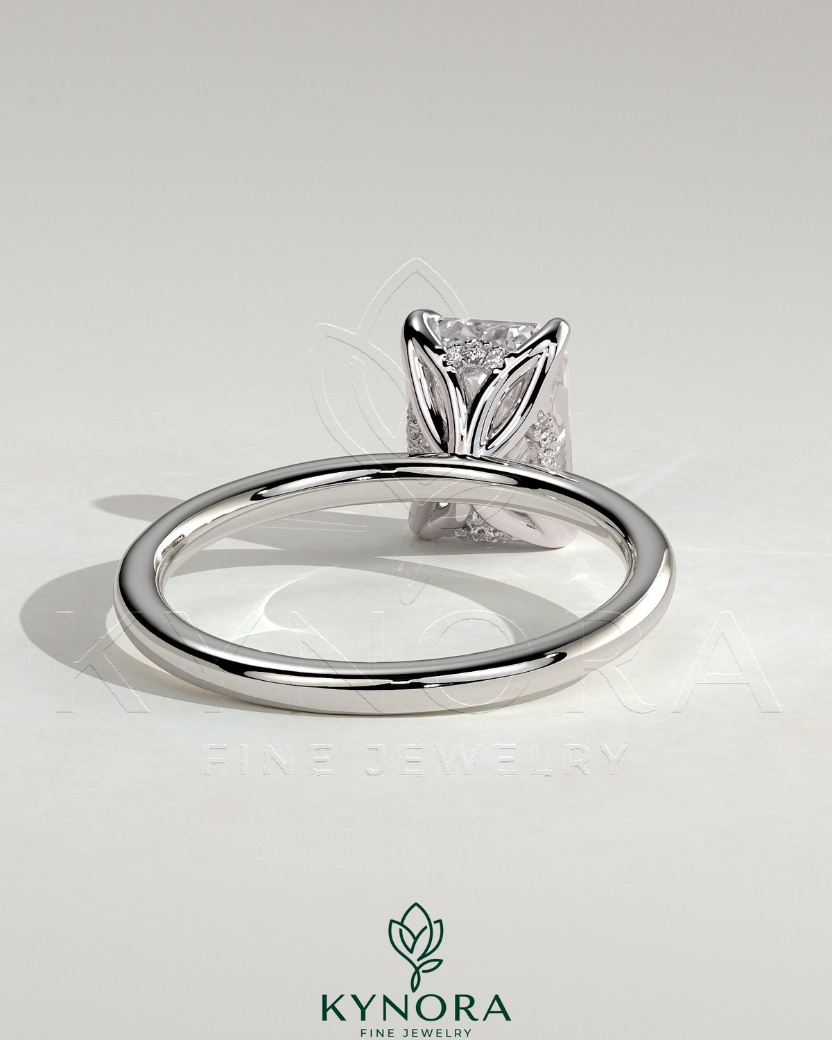 Kynora CJ 2ct emerald claw solitaire engagement ring with petal gallery and accented tiara detail, showcasing intricate craftsmanship.