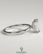 Kynora CJ 2ct emerald claw solitaire engagement ring with petal gallery and accented tiara detail, showcasing intricate craftsmanship.