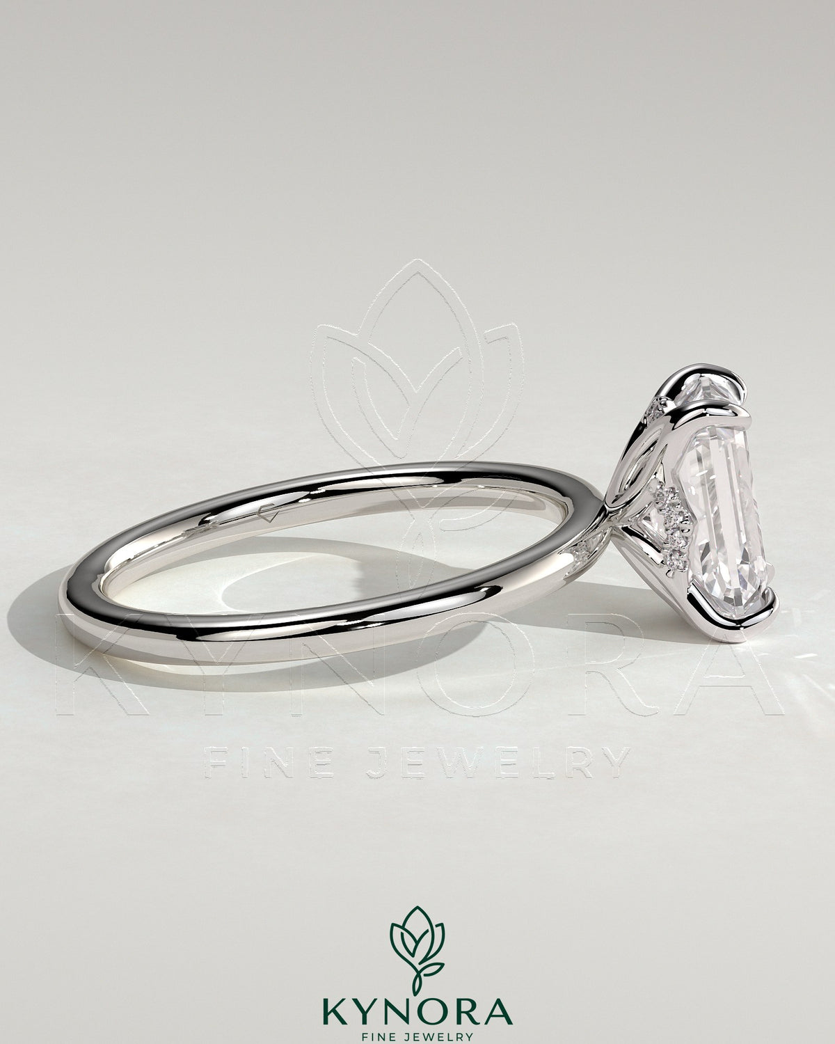 Kynora CJ 2ct emerald claw solitaire engagement ring with petal gallery and accented tiara detail, showcasing intricate craftsmanship.