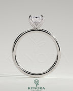 Kynora CJ 2ct emerald claw solitaire engagement ring with petal gallery and accented tiara detail, showcasing intricate design.