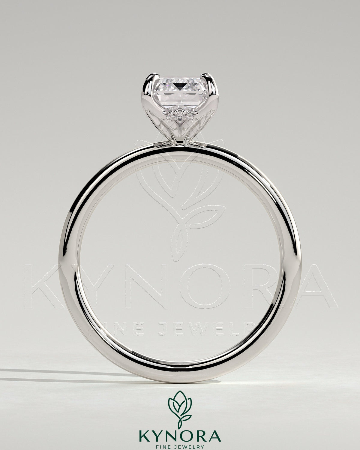 Kynora CJ 2ct emerald claw solitaire engagement ring with petal gallery and accented tiara detail, showcasing intricate design.