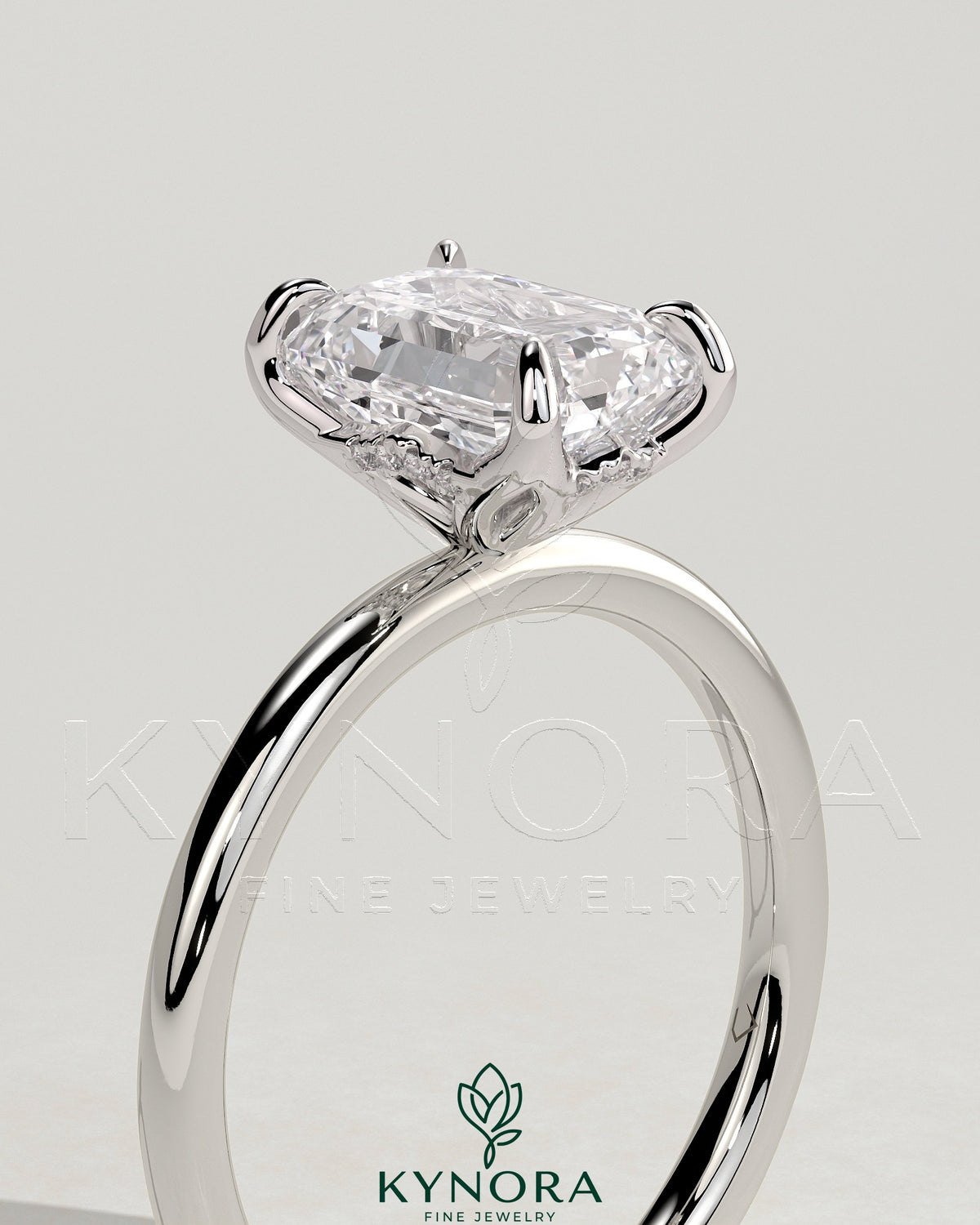 Kynora CJ 2ct emerald claw solitaire engagement ring with petal gallery and accented tiara detail, showcasing intricate design and sparkling gemstone.
