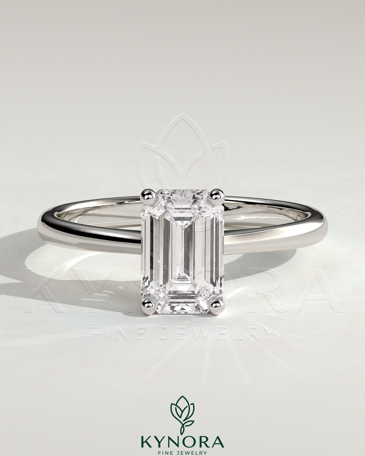 Kynora CJ 2ct emerald claw solitaire engagement ring with tapered band and cathedral low setting, featuring a sparkling emerald gemstone. Main image