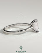 Kynora CJ 2ct emerald claw solitaire engagement ring with tapered band and cathedral low setting, showcasing intricate design and sparkle.