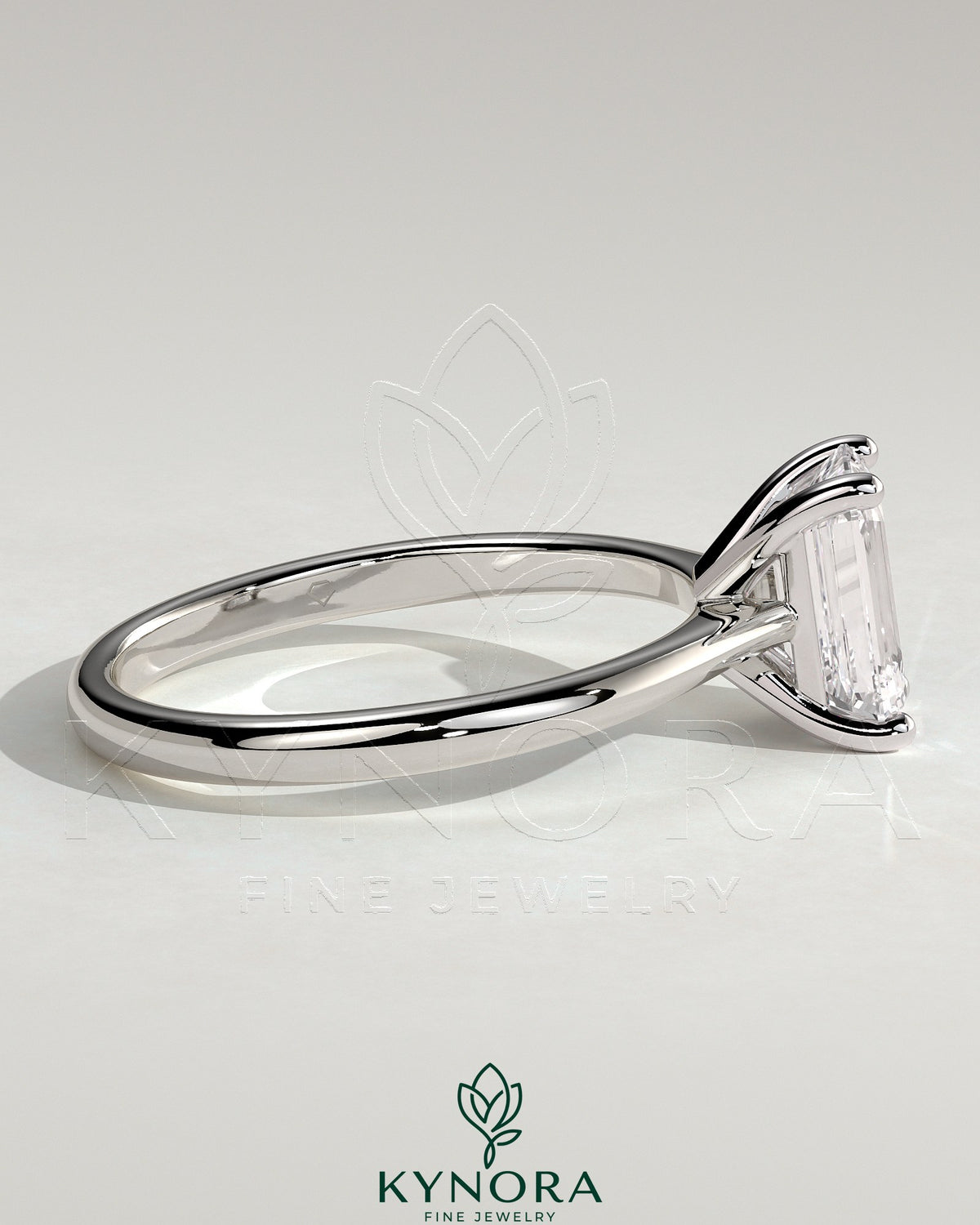 Kynora CJ 2ct emerald claw solitaire engagement ring with tapered band and cathedral low setting, showcasing intricate design and sparkle.