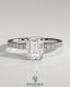 Kynora CJ 2ct emerald claw solitaire engagement ring with wrap-around hidden halo and pave band, showcasing a dazzling center stone.