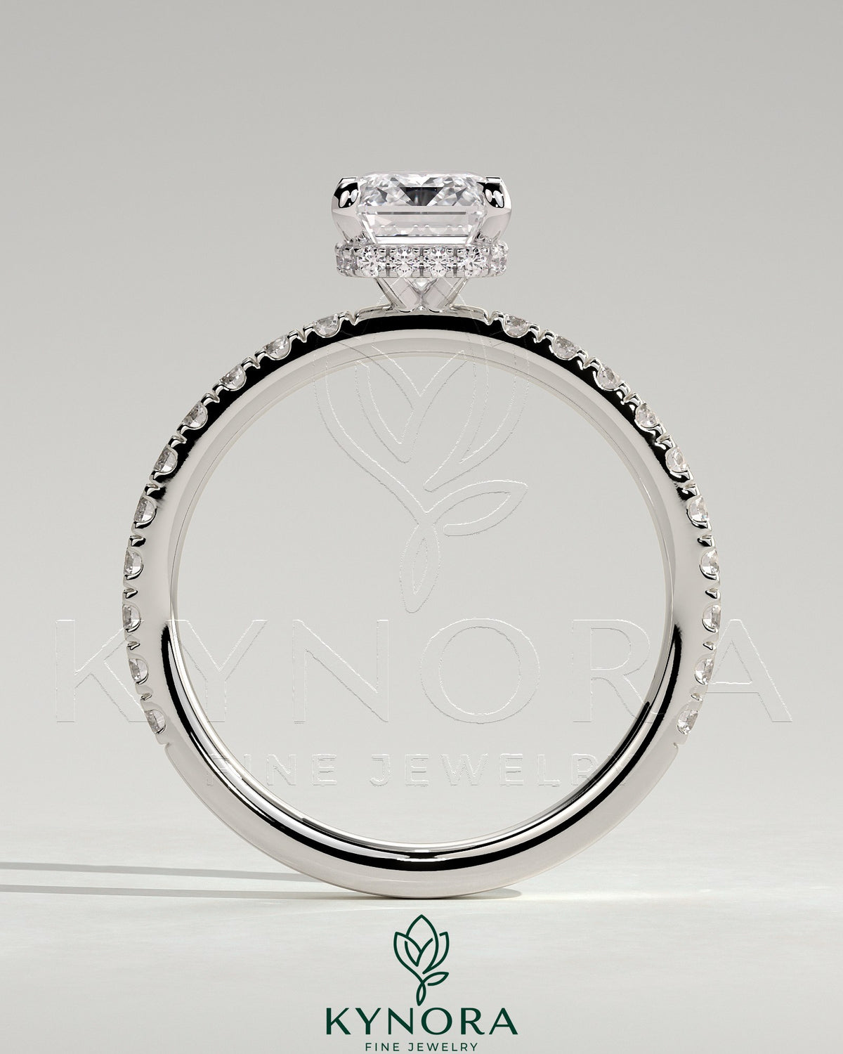 Kynora CJ 2ct emerald claw solitaire engagement ring with wrap-around hidden halo and pave band, detailed jewelry image