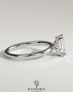 Kynora CJ 2ct emerald claw solitaire engagement ring with a wrap-around hidden halo in sterling silver.