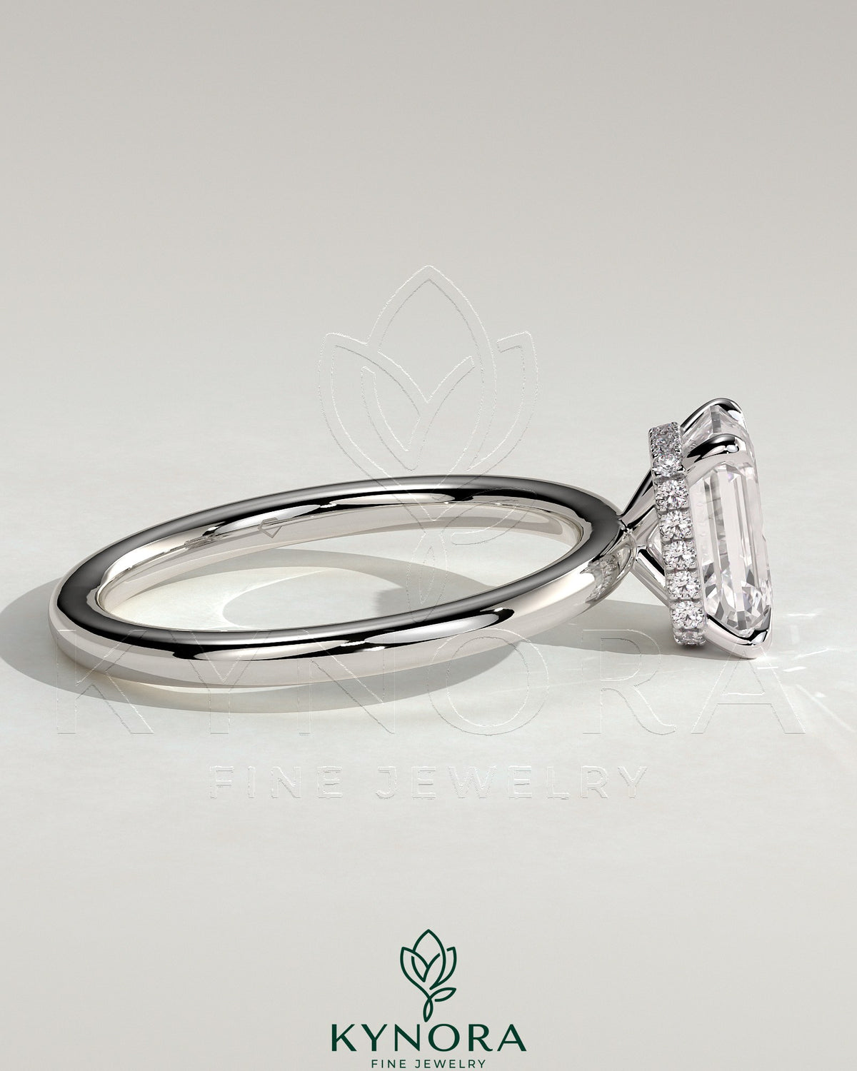 Kynora CJ 2ct emerald claw solitaire engagement ring with a wrap-around hidden halo in sterling silver.