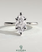 Kynora CJ 2ct marquise cut solitaire engagement ring with six prongs and claw setting, showcasing elegant jewelry craftsmanship.