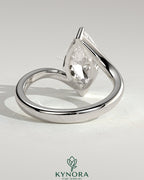 Kynora CJ 2ct marquise solitaire engagement ring with bypass band, featuring a marquise cut diamond and sleek gold setting.
