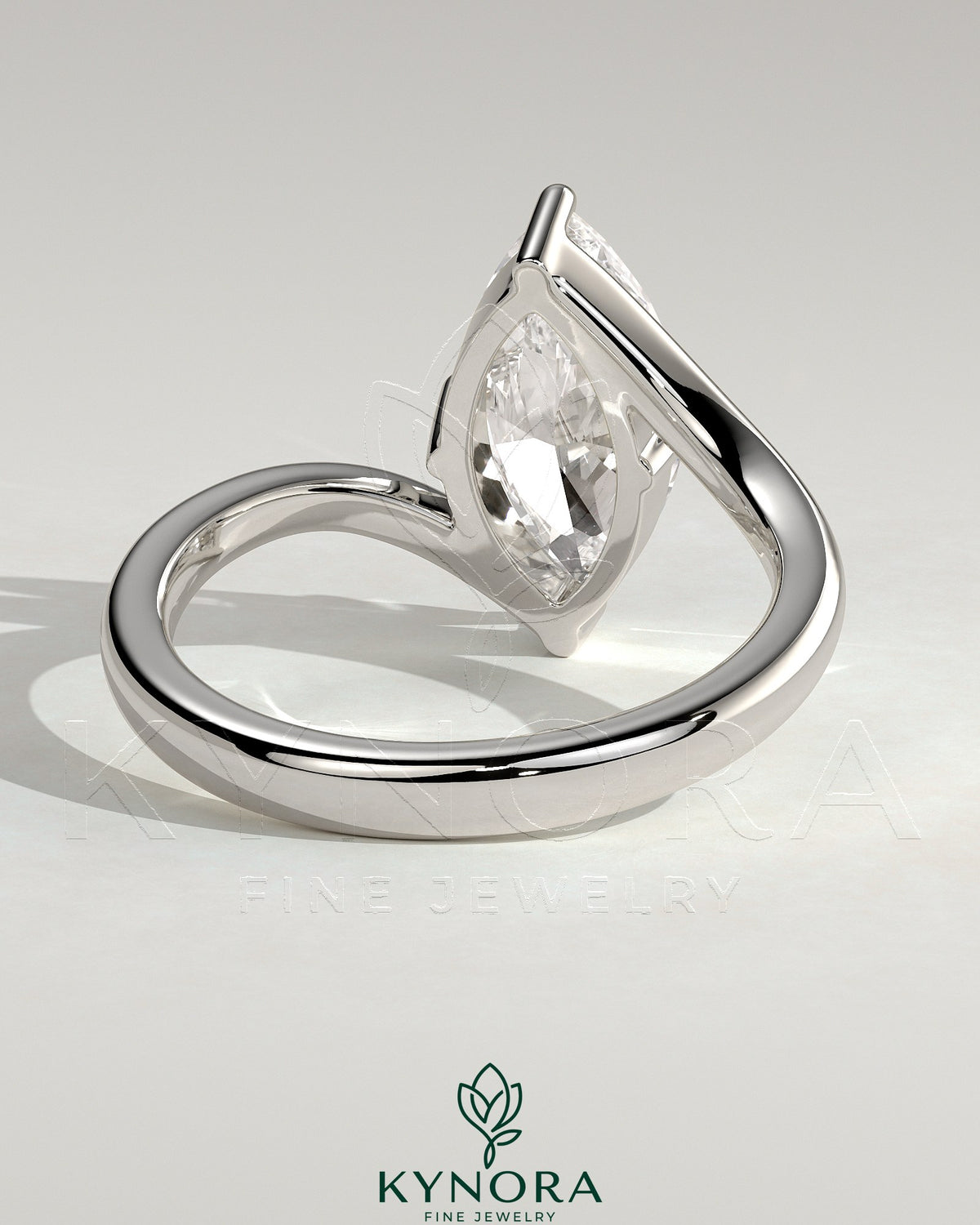 Kynora CJ 2ct marquise solitaire engagement ring with bypass band, featuring a marquise cut diamond and sleek gold setting.