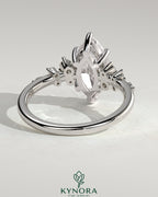 Kynora CJ 2ct marquise claw solitaire engagement ring with clustered round shoulder stones, sparkling and elegant jewelry piece.