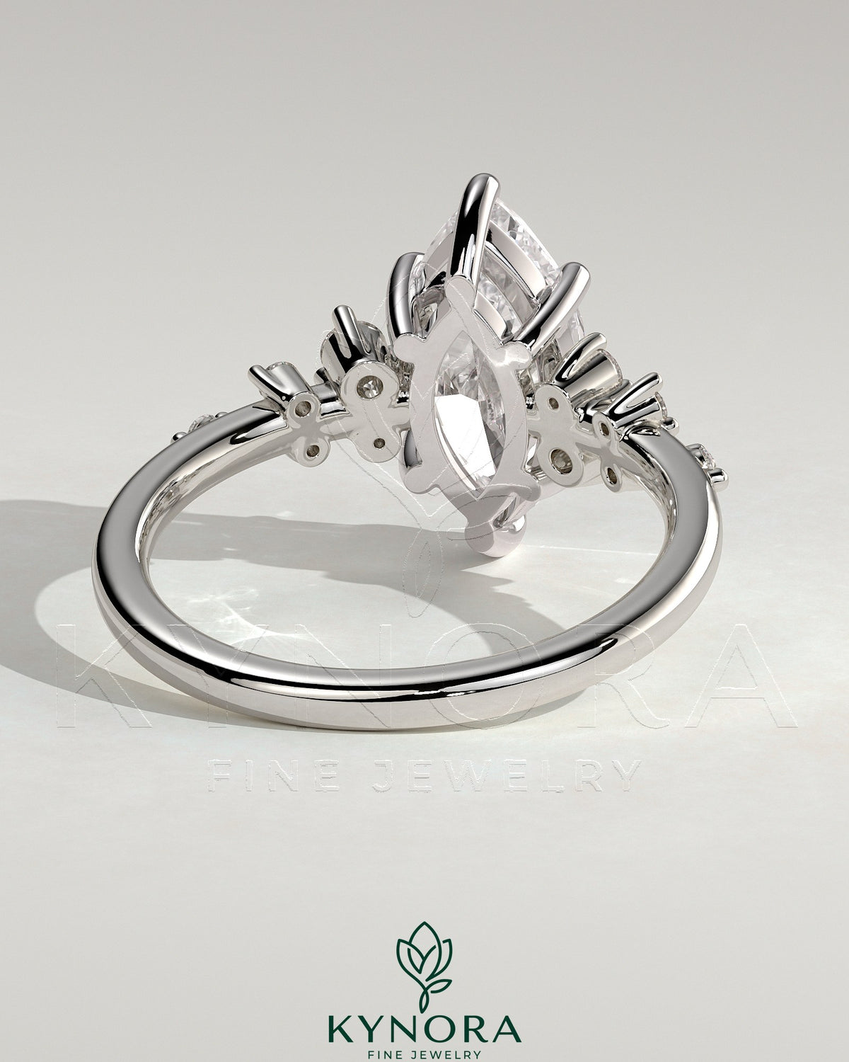 Kynora CJ 2ct marquise claw solitaire engagement ring with clustered round shoulder stones, sparkling and elegant jewelry piece.