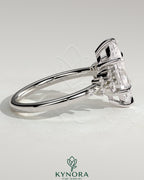 Kynora CJ 2ct marquise solitaire engagement ring with clustered round shoulder stones and elegant design.