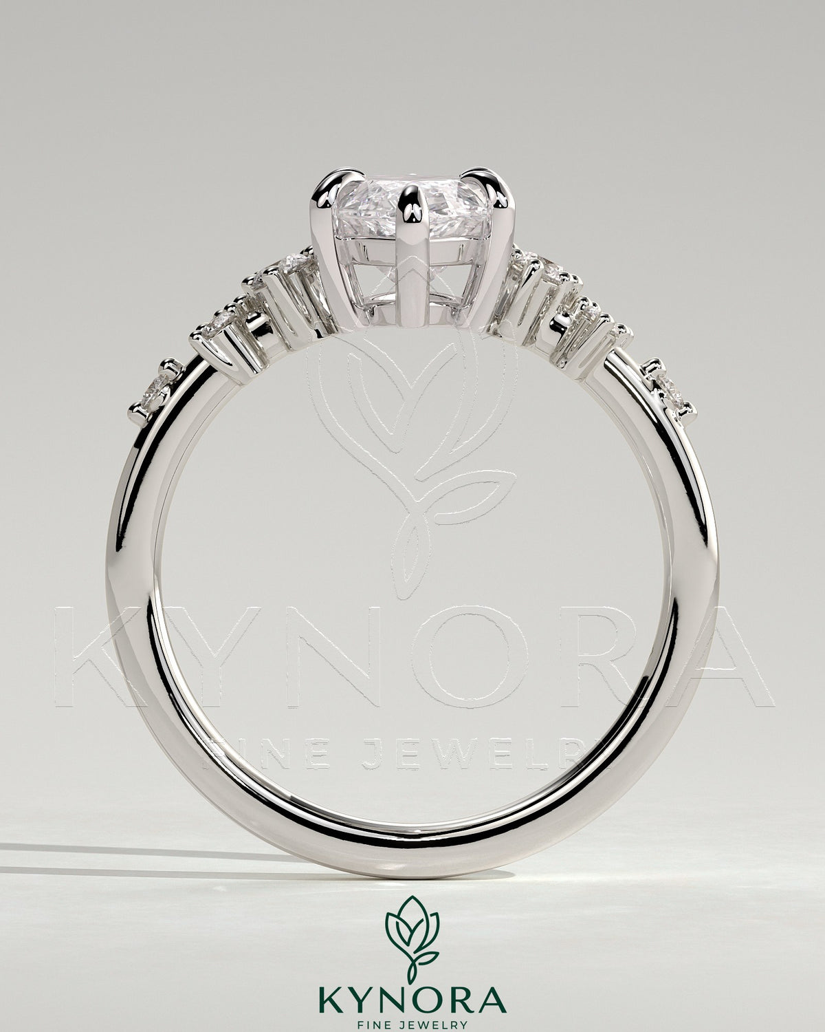 Kynora CJ 2ct marquise claw solitaire engagement ring with clustered round shoulder stones, showcasing elegant jewelry craftsmanship.