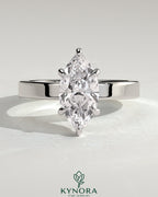 Kynora CJ 2-carat marquise claw solitaire engagement ring with flat cigar band and hidden halo, showcasing a sparkling marquise diamond.