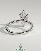 Kynora CJ 2ct marquise claw solitaire engagement ring with hidden halo and pavé band, showcasing sparkling diamond details.