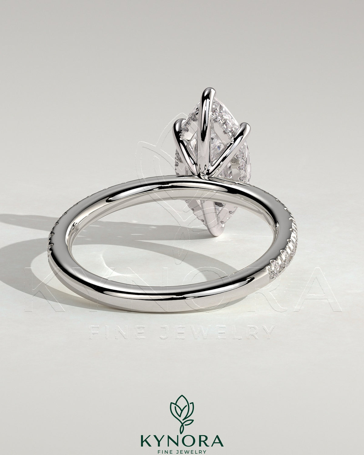 Kynora CJ 2ct marquise claw solitaire engagement ring with hidden halo and pavé band, showcasing sparkling diamond details.