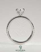 Kynora CJ 2ct marquise claw solitaire engagement ring with hidden halo and pave band, showcasing sparkling diamond details.