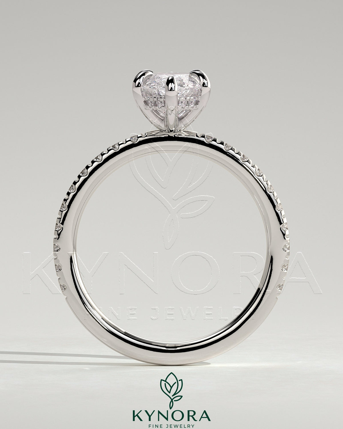 Kynora CJ 2ct marquise claw solitaire engagement ring with hidden halo and pave band, showcasing sparkling diamond details.