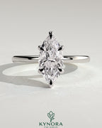 Kynora CJ 2ct marquise diamond solitaire engagement ring with hidden halo and six prong setting on a silver band.