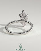 Kynora CJ 2ct marquise diamond solitaire engagement ring with hidden halo and six prong setting on a silver band.