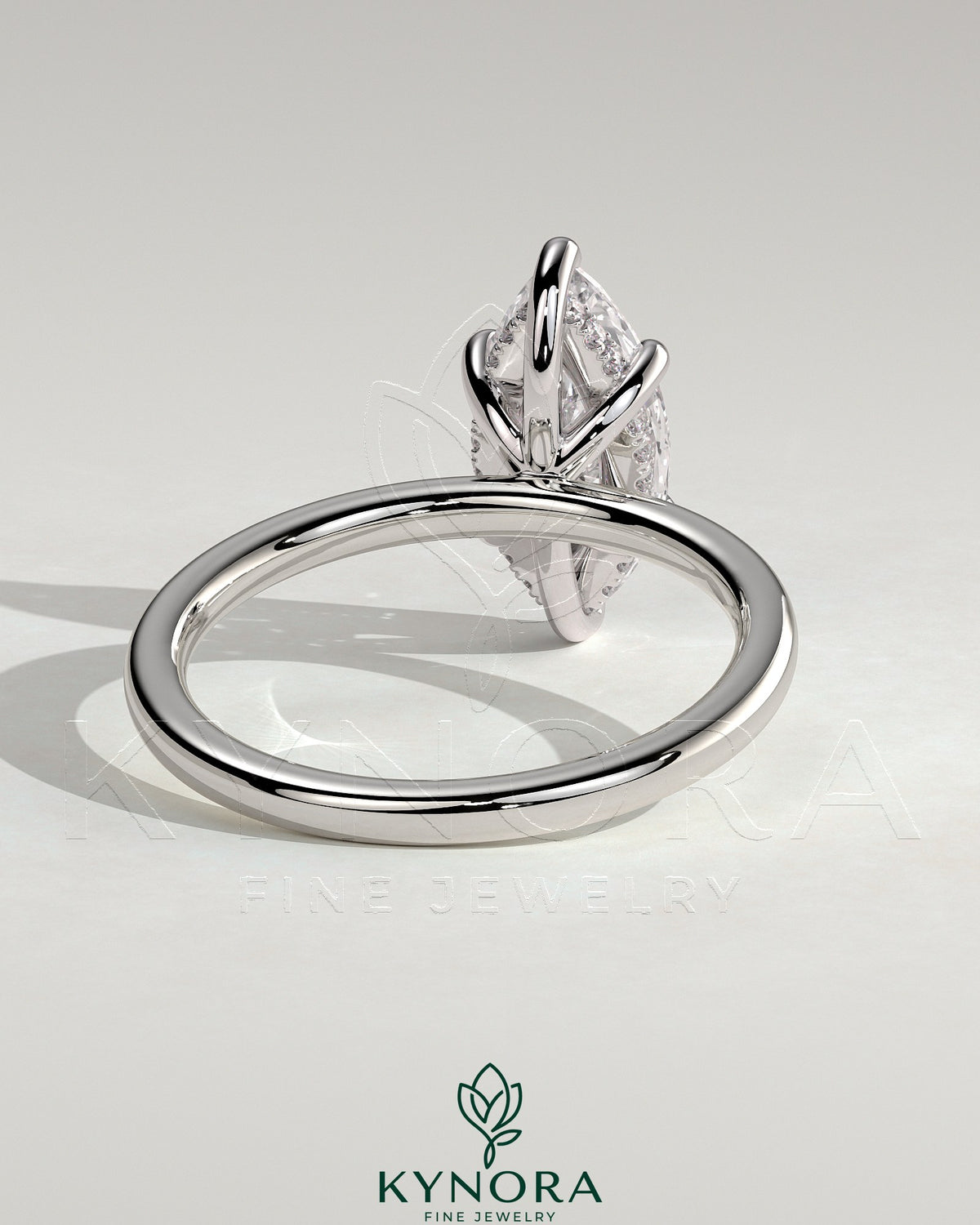 Kynora CJ 2ct marquise diamond solitaire engagement ring with hidden halo and six prong setting on a silver band.