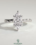 Kynora CJ 2ct marquise claw solitaire engagement ring with hidden halo, opposing marquise accents, cathedral high setting.