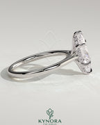 Kynora CJ 2ct marquise claw solitaire engagement ring with hidden halo, tapered band, and cathedral high setting in jewelry image.