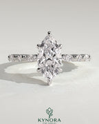Kynora CJ 2ct marquise claw solitaire engagement ring with marquise and round accent stones, elegant and sparkling jewelry.