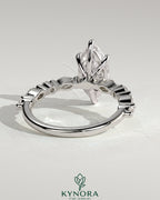 Kynora CJ 2ct marquise claw solitaire engagement ring with marquise and round accent stones, showcasing elegant jewelry design