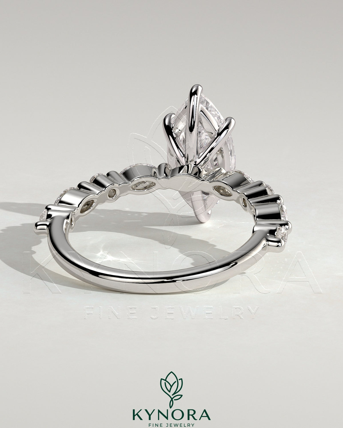 Kynora CJ 2ct marquise claw solitaire engagement ring with marquise and round accent stones, showcasing elegant jewelry design