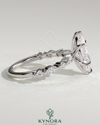 Kynora CJ 2ct marquise claw solitaire engagement ring with marquise and round accent stones, elegant and sparkling jewelry piece