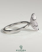 Kynora CJ 2ct marquise claw solitaire engagement ring with petal gallery and accent leaf details, showcasing fine craftsmanship.