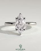 Kynora CJ 2ct Marquise claw solitaire engagement ring with petal gallery design in shiny metal setting.