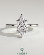 Kynora CJ 2ct marquise claw solitaire engagement ring with a wrap-around hidden halo, showcasing elegant diamond craftsmanship.