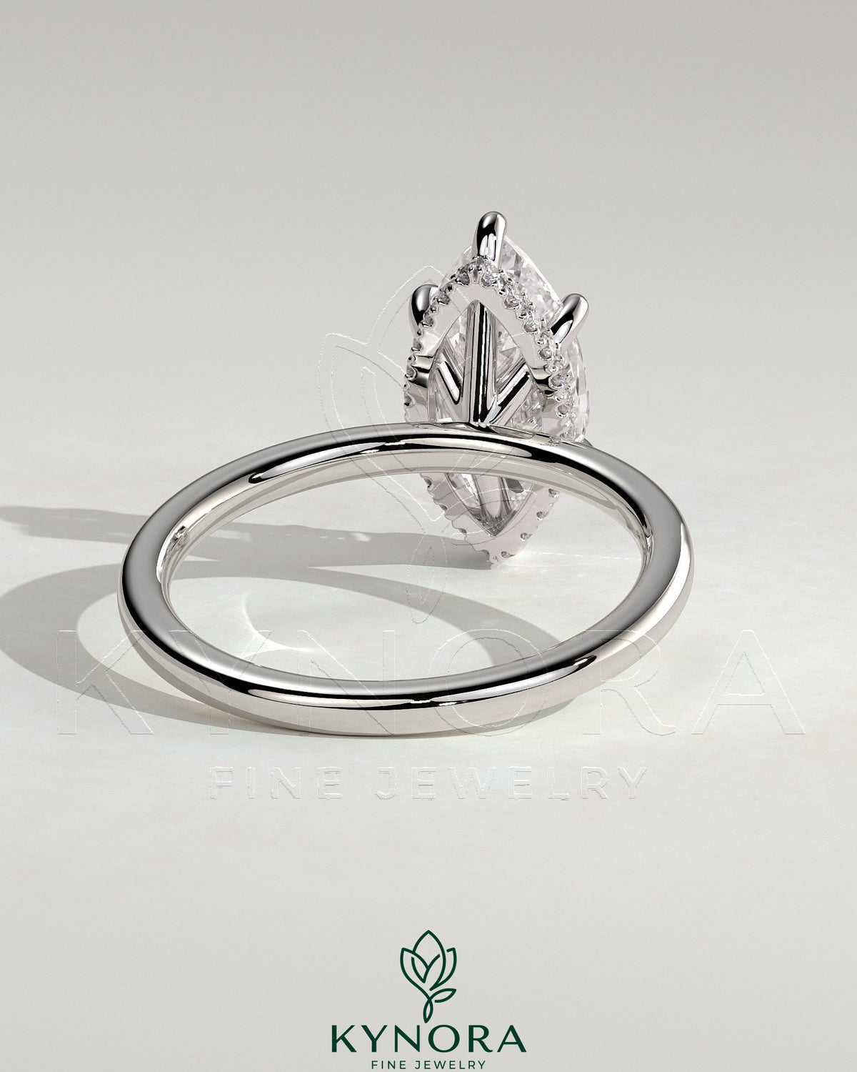 Kynora CJ 2ct marquise claw solitaire engagement ring with a wrap-around hidden halo and intricate band design.