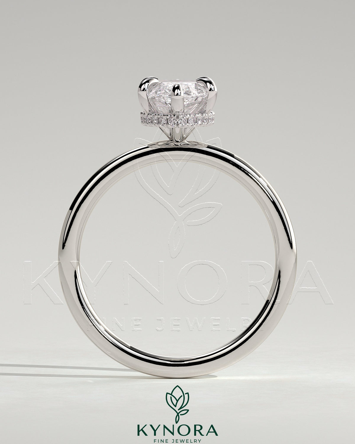 Kynora CJ 2ct marquise claw solitaire engagement ring with a wrap-around hidden halo setting, showcasing fine jewelry craftsmanship.