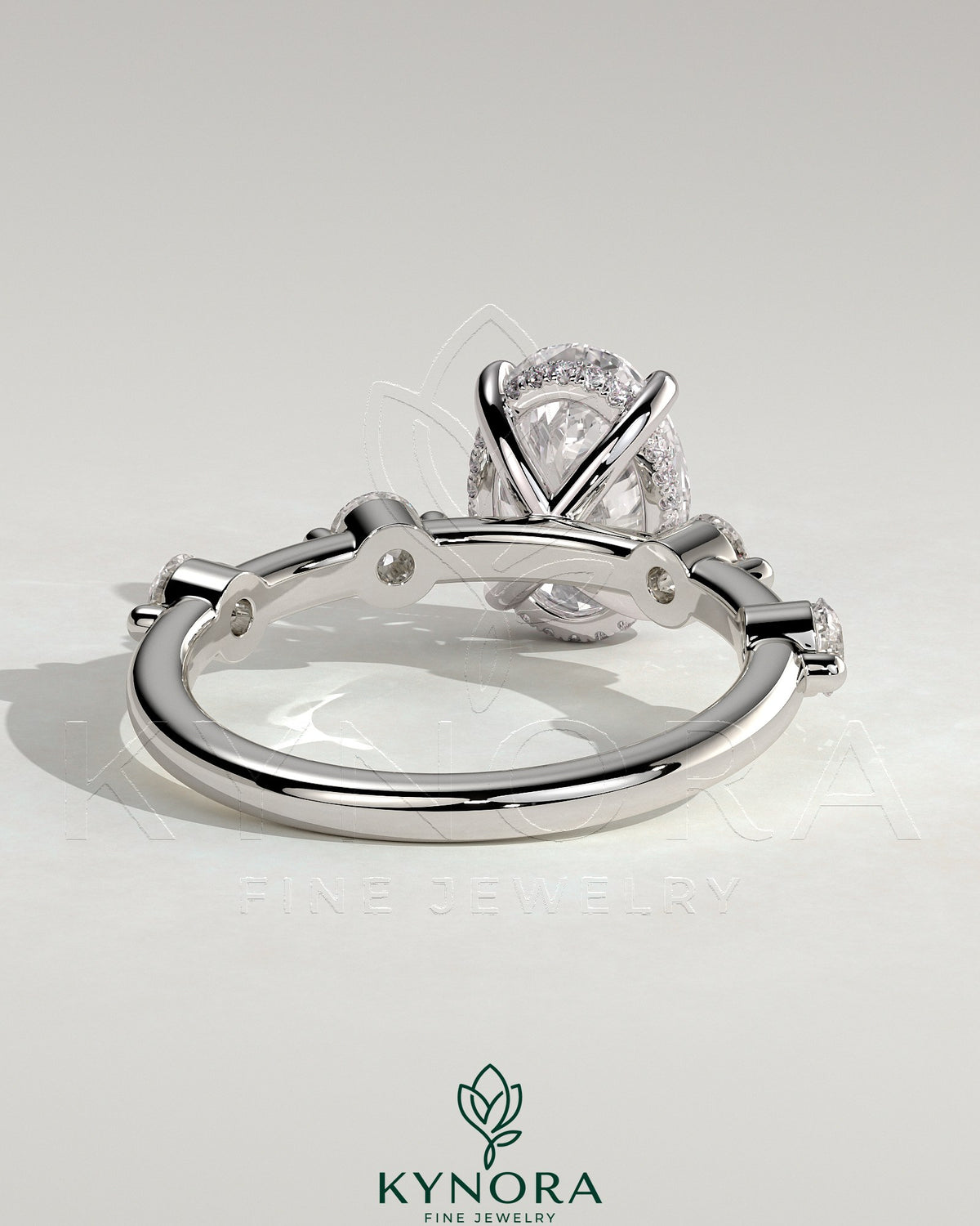 Kynora CJ 2ct oval claw solitaire engagement ring with four round accent stones and hidden halo setting, elegant jewelry design