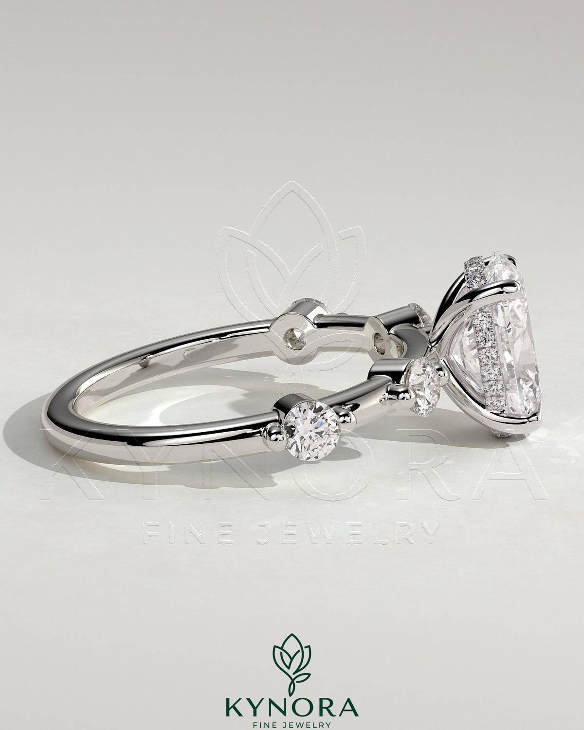Kynora CJ 2ct oval claw solitaire engagement ring with four round accent stones and hidden halo design.