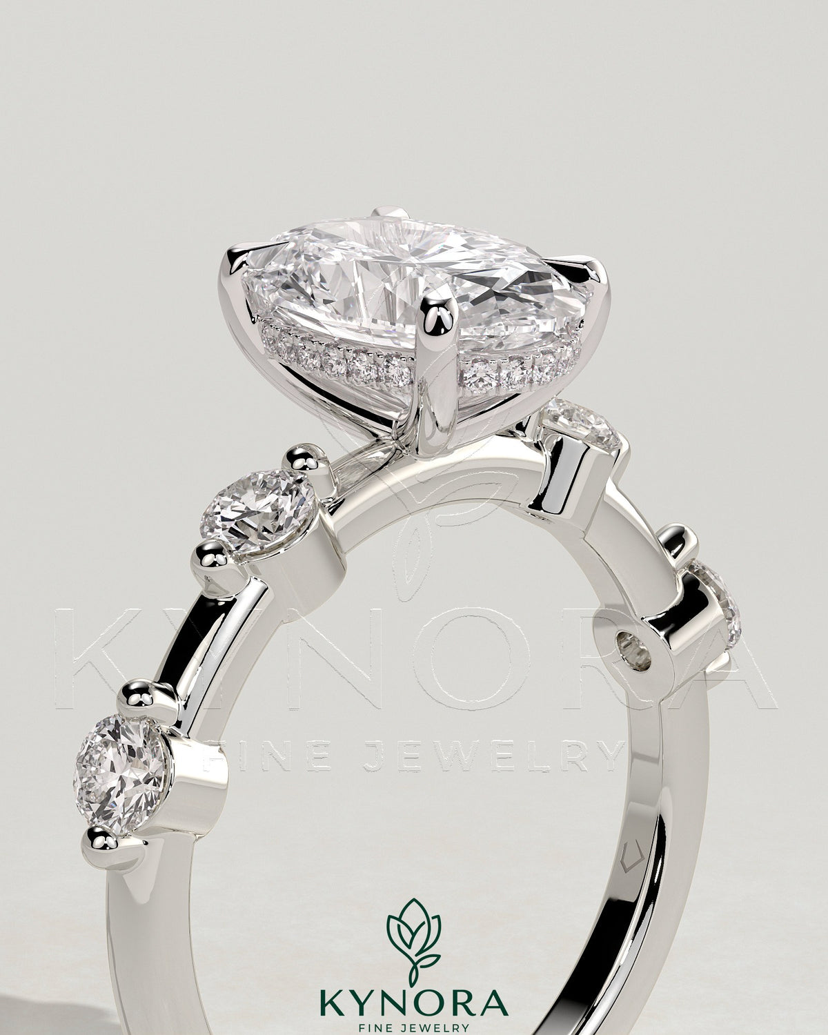 Kynora CJ 2ct oval claw solitaire engagement ring with four round accent stones and a hidden halo design.
