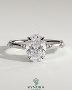 Kynora CJ 2ct oval claw solitaire engagement ring with six accent stones and hidden halo, showcasing sparkling diamond details.