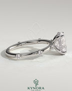 Kynora CJ 2ct oval claw solitaire engagement ring with six round accent stones and hidden halo setting.