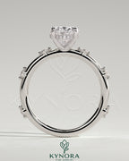 Kynora CJ 2ct oval claw solitaire engagement ring with six round accent stones and hidden halo setting.